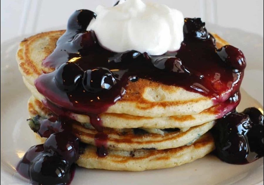 Stack of golden pancakes with butter